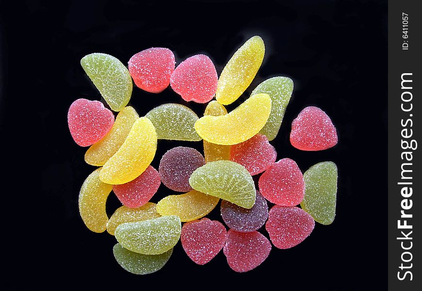 Multi-coloured fruit candy on a black background