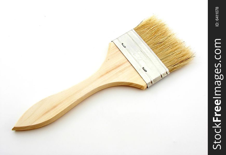 Wooden paint brush isoltad over white background.