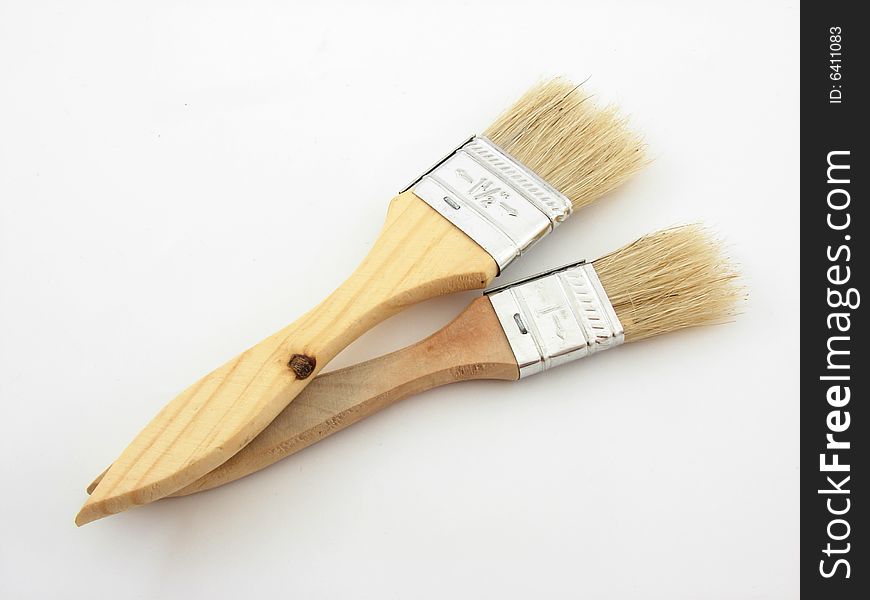 Wooden paint brushes isoltad over white background.