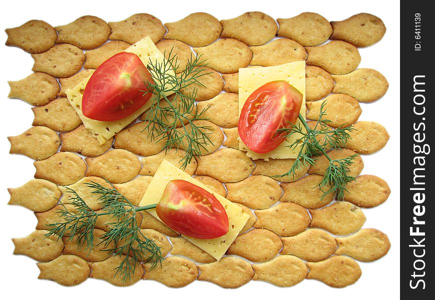 Tomato pieces on cheese slices and cracker. Tomato pieces on cheese slices and cracker