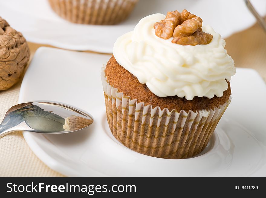 Walnuts muffins with mascarpone cheese (whipped cream).