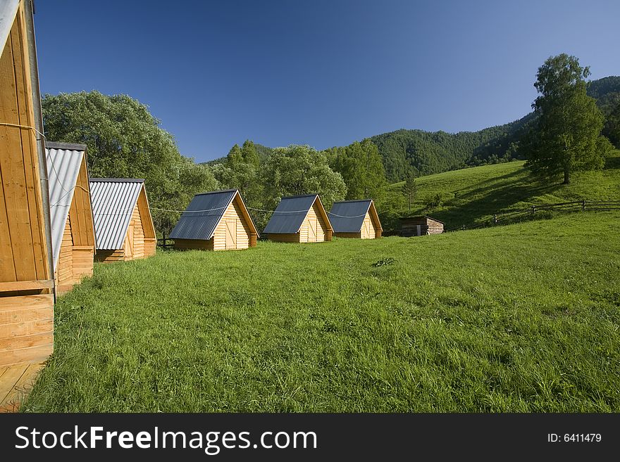Summer tourist camp, small houses on a green field