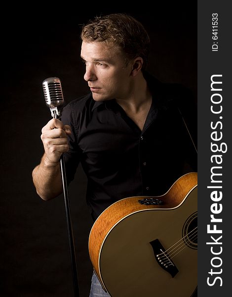 Young musician playing a guitar and singing