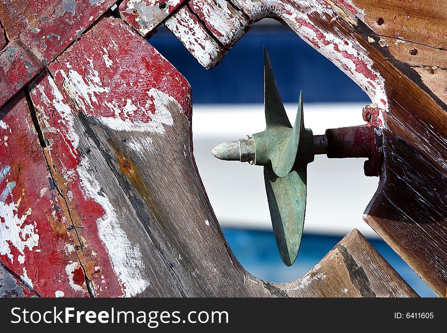 Old rusty propeller on wooden boat in dry dock. Old rusty propeller on wooden boat in dry dock