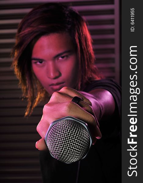 Picture of a young generation rock star with a microphone. Suitable for musical related contexts. Picture of a young generation rock star with a microphone. Suitable for musical related contexts.