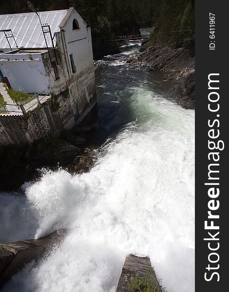 Hydroelectric power station building, summer, water flow