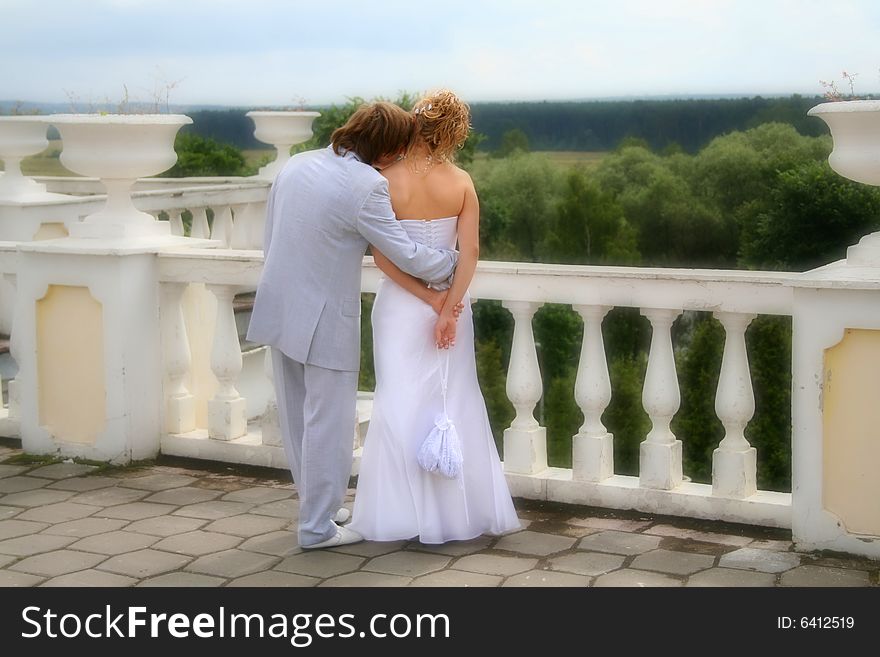 Fiance and bride walking. White column. Soft focus. Fiance and bride walking. White column. Soft focus