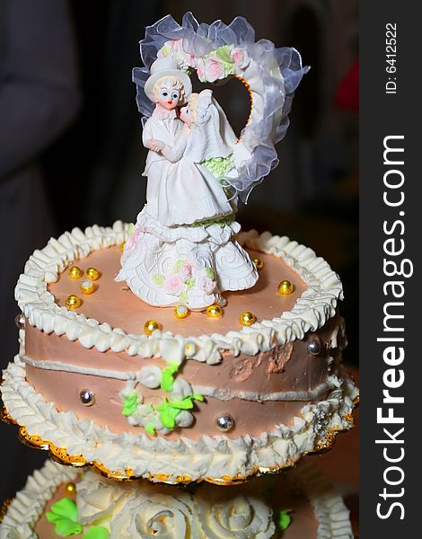 Bride and fiance on the top of the cake. Bride and fiance on the top of the cake