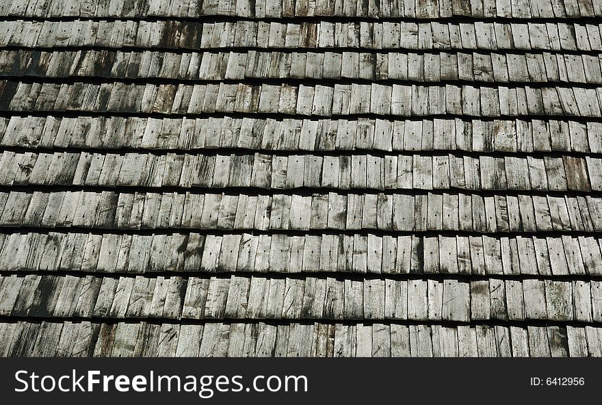 A fragment of withered wooden shingles upon an ancient watchtower