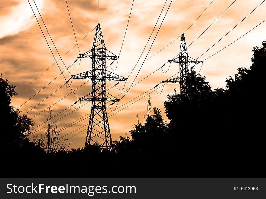 Power lines and electric pylon on a background of sky