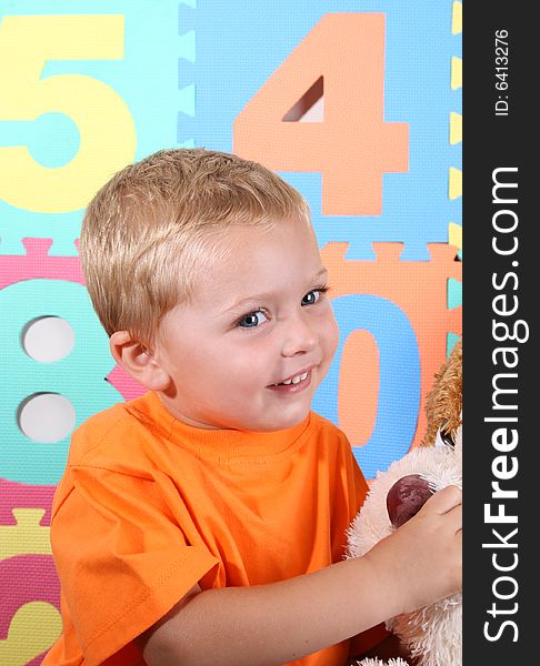 Blond Toddler playing against a colorful background. Blond Toddler playing against a colorful background