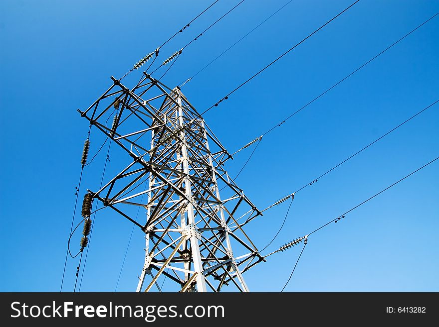 Power lines and electric pylon on a background of sky