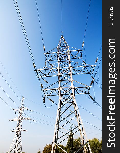 Power lines and electric pylon on a background of sky