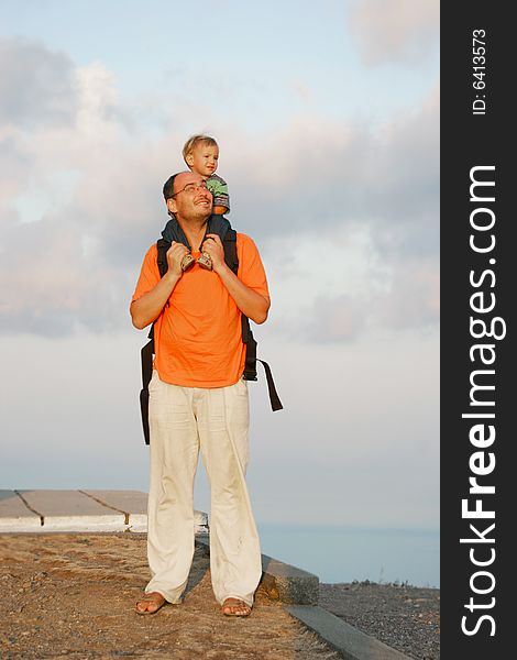 Father and son on sky background