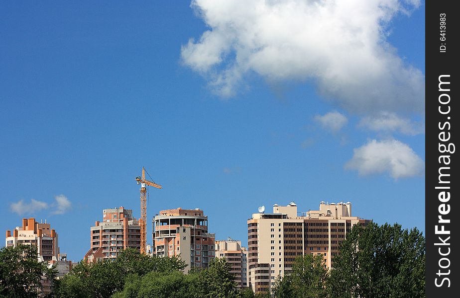 A under construction houses on a background of the blue sky