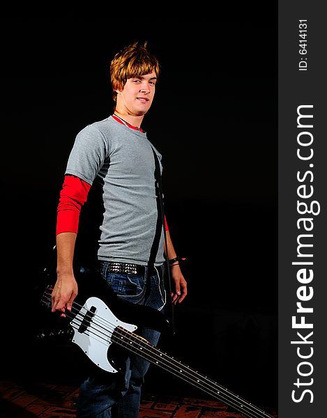 Portrait of young trendy electric bass player isolated. Portrait of young trendy electric bass player isolated
