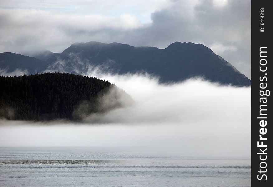 Alaskan landscape with mountains and thick fog. Alaskan landscape with mountains and thick fog.