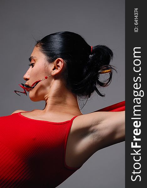 Artistic portrait of young hispanic dancer woman in red clothes. Artistic portrait of young hispanic dancer woman in red clothes