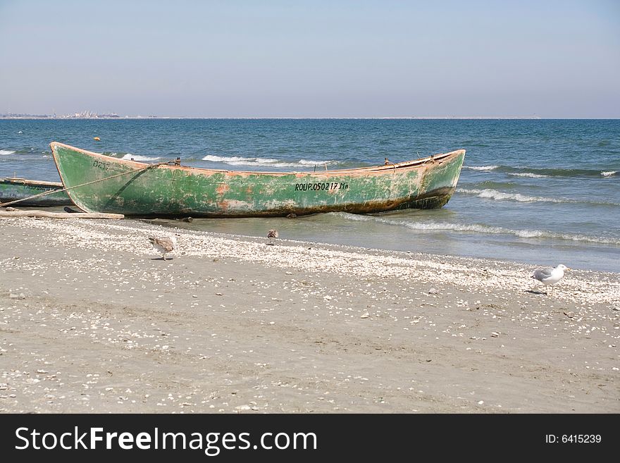 Green boat on the beach