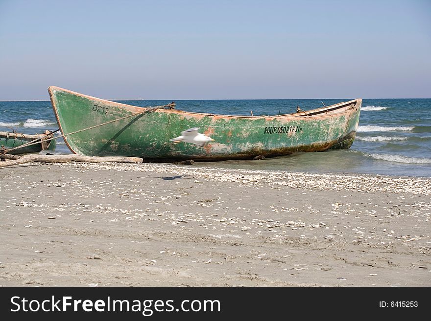 Green boat on the beach