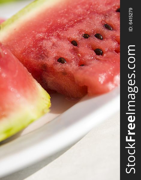 Slices of juicy watermelon on white plate. Slices of juicy watermelon on white plate