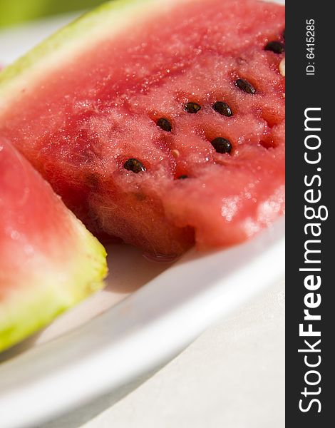 Slices of juicy watermelon on white plate. Slices of juicy watermelon on white plate