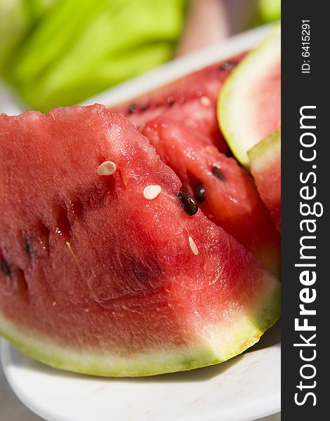 Slices of juicy watermelon on white plate. Slices of juicy watermelon on white plate