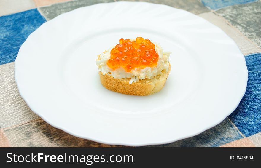 Caviar sandwich on white plate
