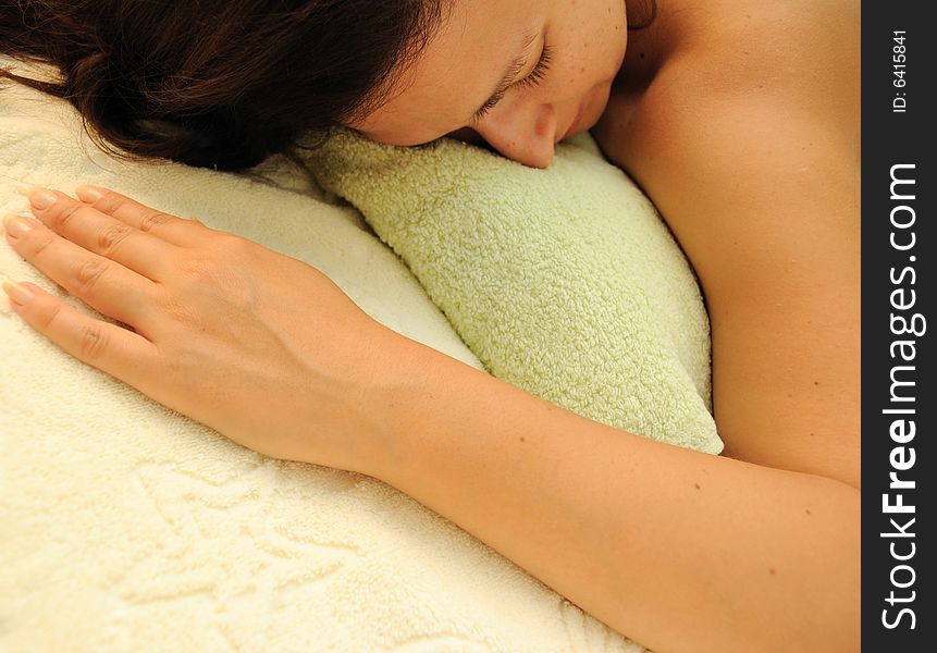 Concept of spa - female laying over towels