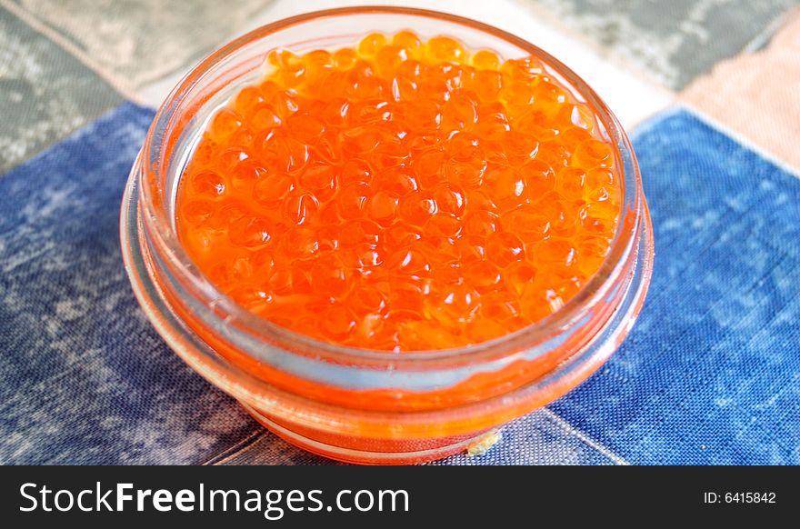 Glass jar full of salmon caviar