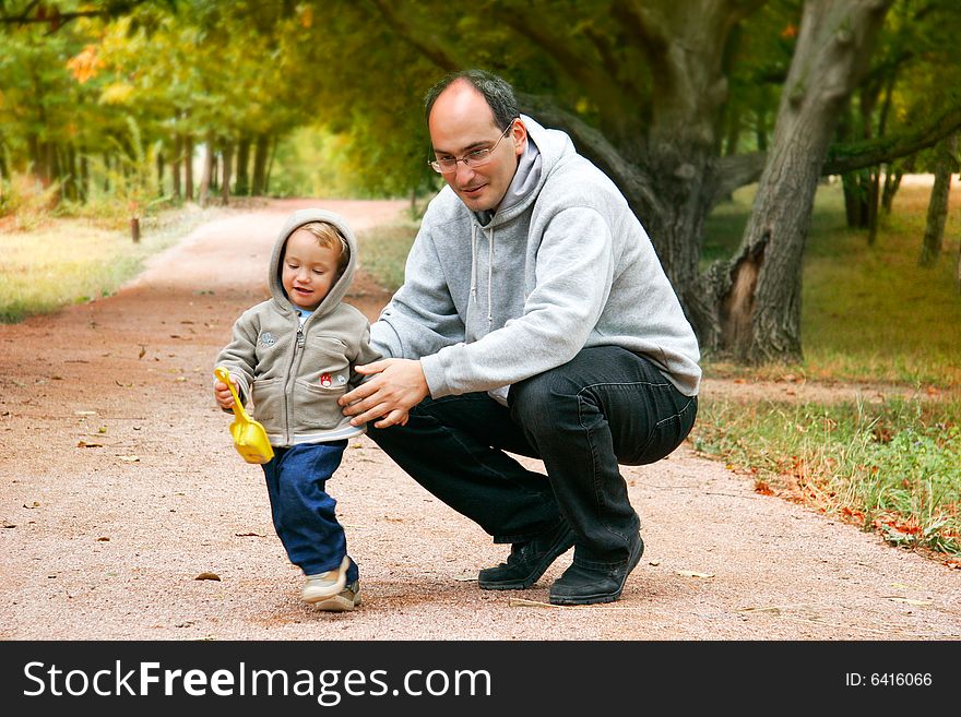 Father and son in autumn park