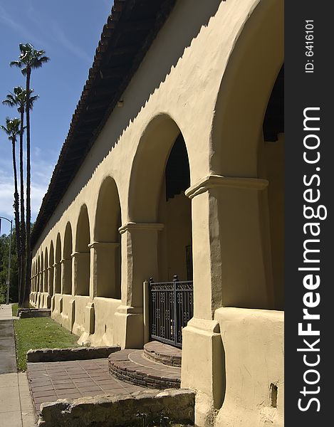 Tall Palm trees and the arches of the long building of Mission San Fernando, California. Tall Palm trees and the arches of the long building of Mission San Fernando, California.