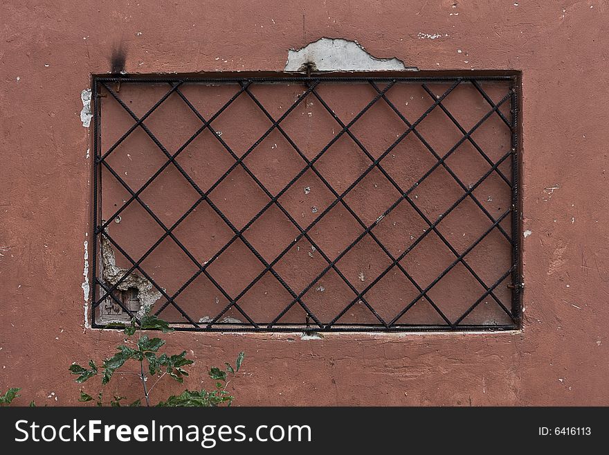 Locked window with black grate on it