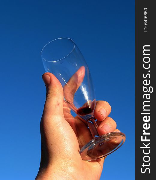 Hand holding an empty red wine glass. Hand holding an empty red wine glass