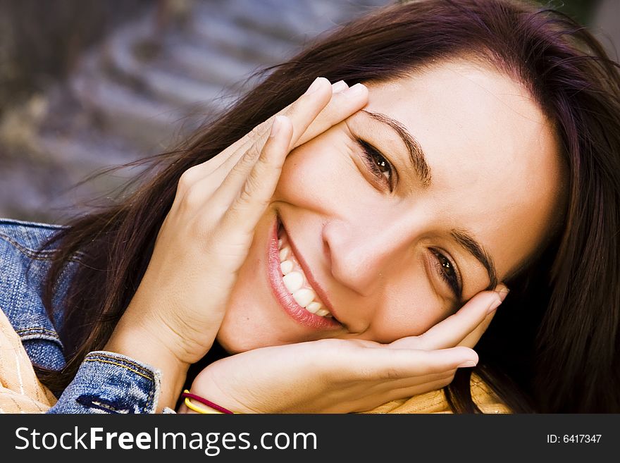 Smiling woman holding her face cheerly. Smiling woman holding her face cheerly.