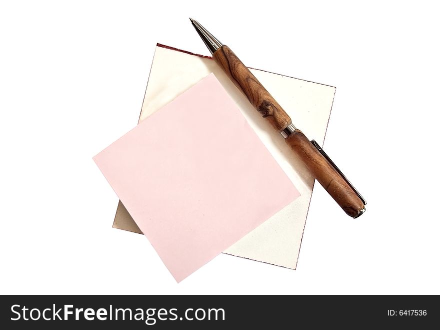 Two writing tablets with a homemade wooden pen on top. Two writing tablets with a homemade wooden pen on top.