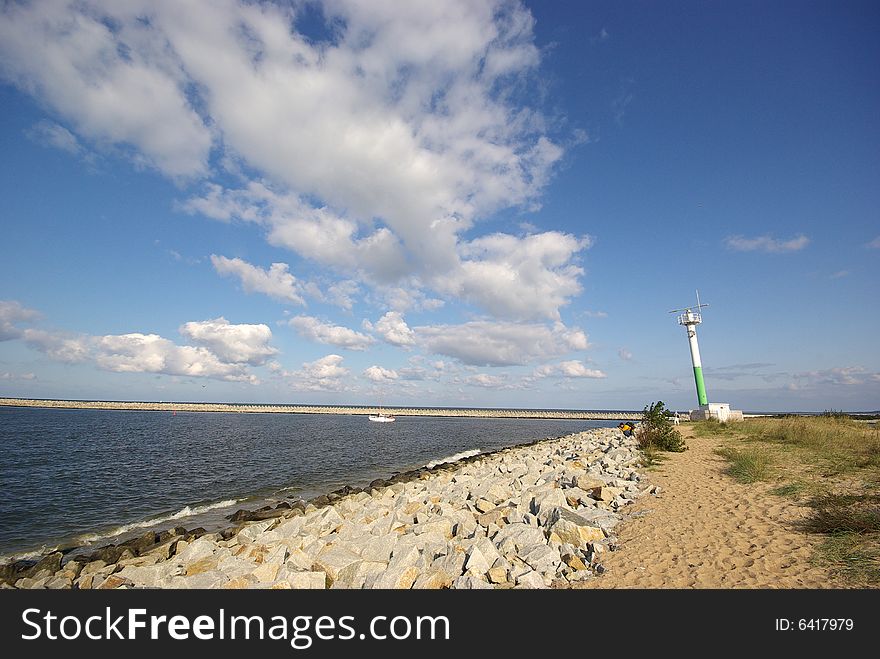 The European summer beach scene. Blue Sky with clouds. The European summer beach scene. Blue Sky with clouds.