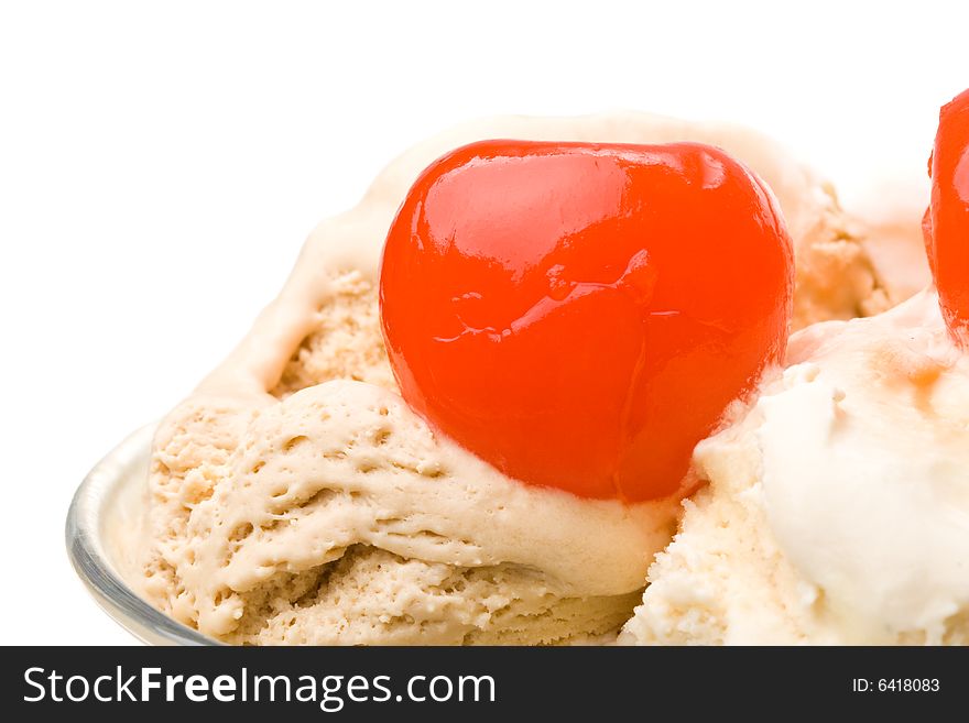 Ice-cream with a cherry in a glass on a white background. Ice-cream with a cherry in a glass on a white background.