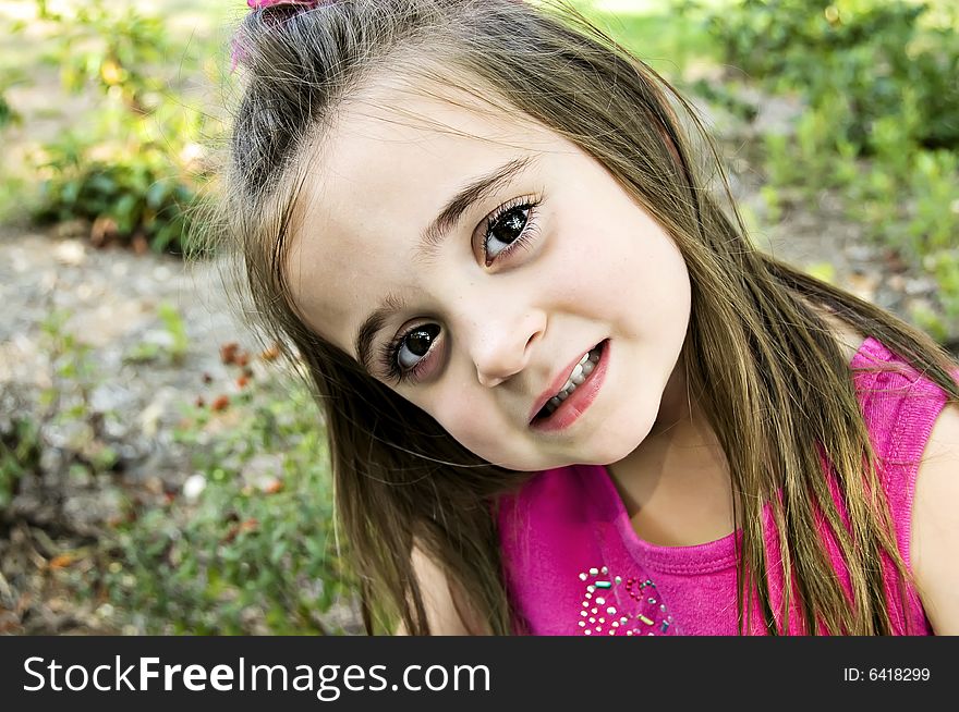 Big Brown eyes, closeup, and a beautiful child dressed in pink with long brunette hair. Big Brown eyes, closeup, and a beautiful child dressed in pink with long brunette hair.