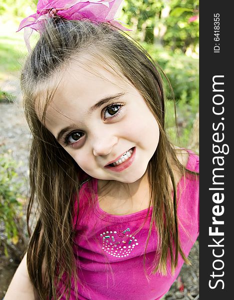 Beautiful young toddler child with brown hair and brown eyes and her hair a bit messed-up. Beautiful young toddler child with brown hair and brown eyes and her hair a bit messed-up.