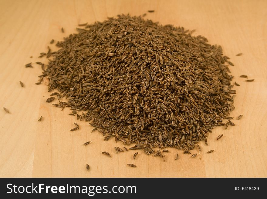 Cumin seeds on wooden surface