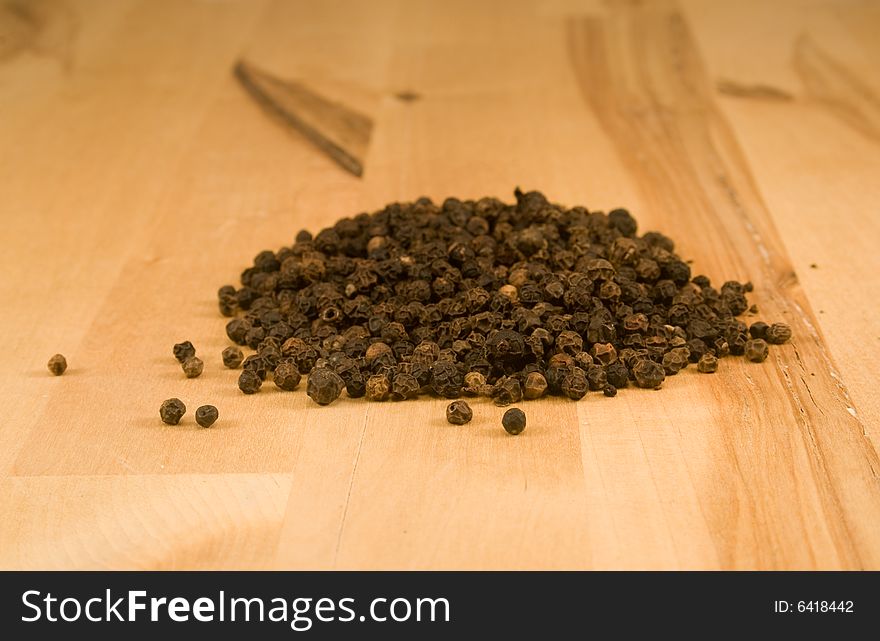 Peppercorns on wood kitchen counter