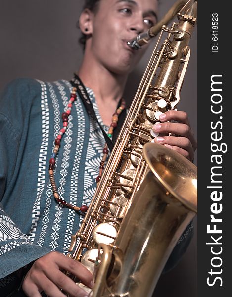 Portrait of young man playing saxophone