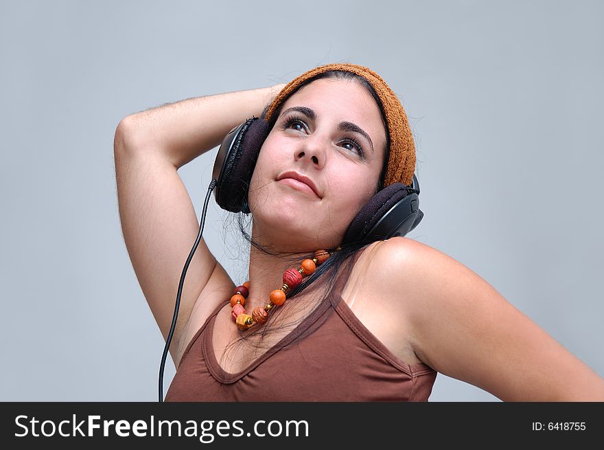 Portrait of young hispanic female listening music with headphones. Portrait of young hispanic female listening music with headphones