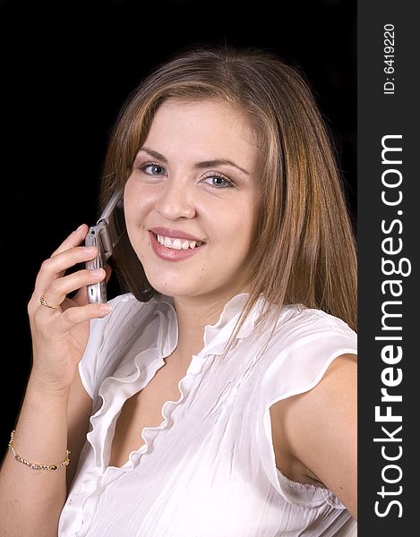 Closeup of pretty hispanic model on cell phone isolated over black