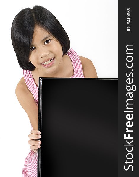 Young pretty Eurasian Chinese girl in pink dress holding up large black rectangle. Young pretty Eurasian Chinese girl in pink dress holding up large black rectangle