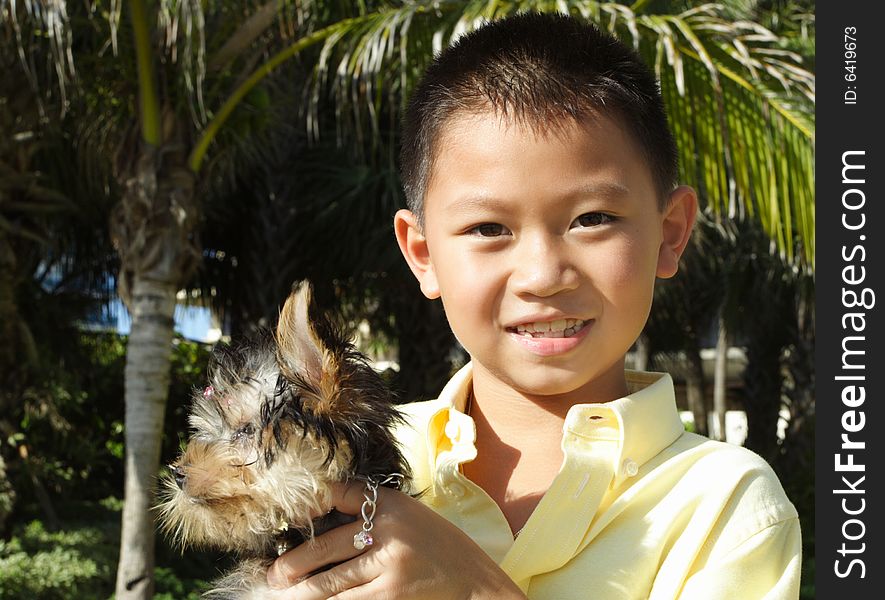 Young child holding his yorkie. Young child holding his yorkie