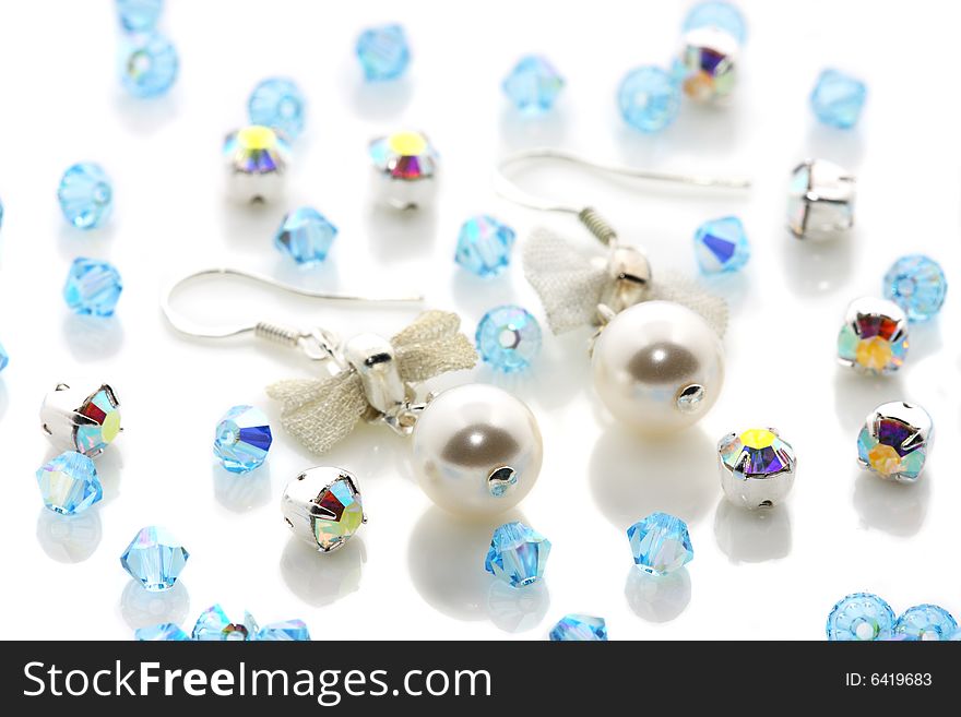 A pair of pearl earrings puts together with beads. A pair of pearl earrings puts together with beads.