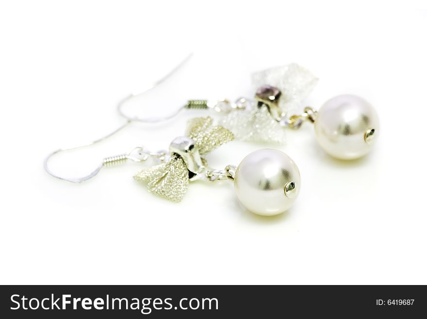 A pair of pearl earrings isolated on white background.