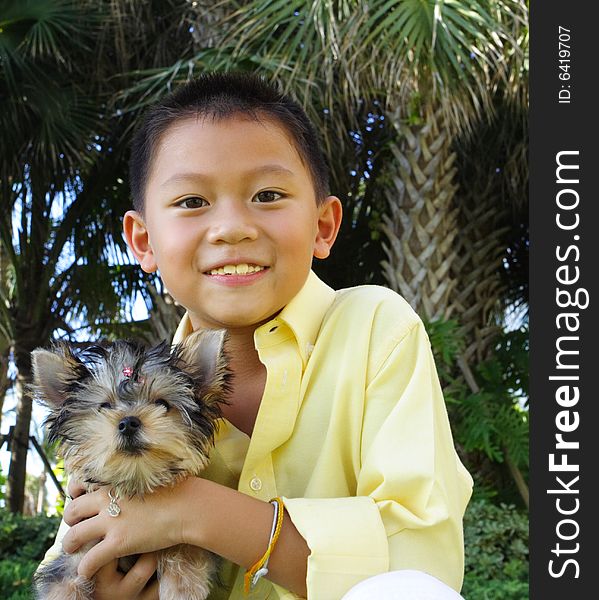 Young child holding his yorkie. Young child holding his yorkie